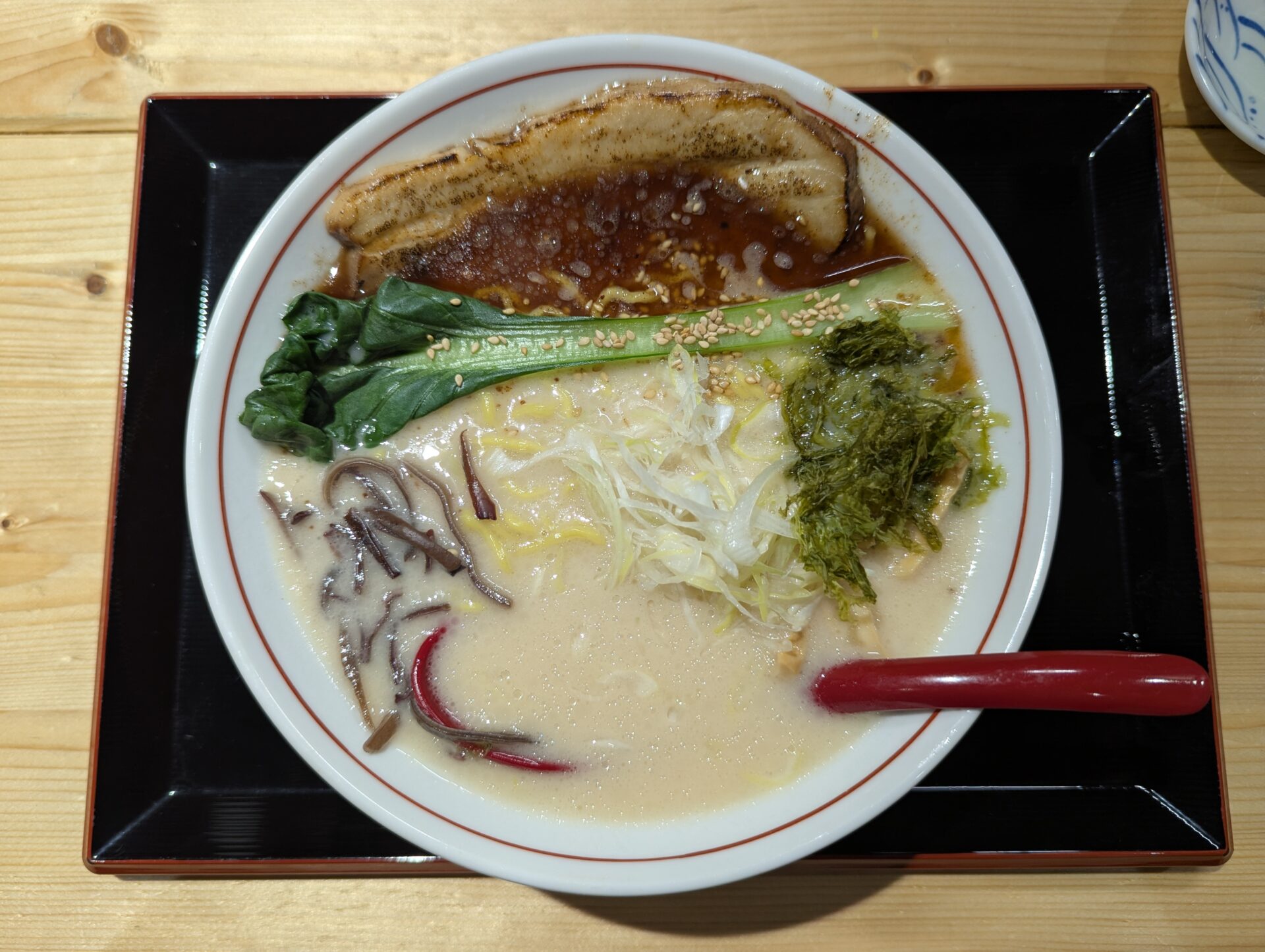 店内で提供された「わ〜るど」のとんこつ白湯塩ラーメン。白濁スープに野菜やチャーシューが美しく盛り付けられ、彩りも豊かで食欲をそそる一杯。