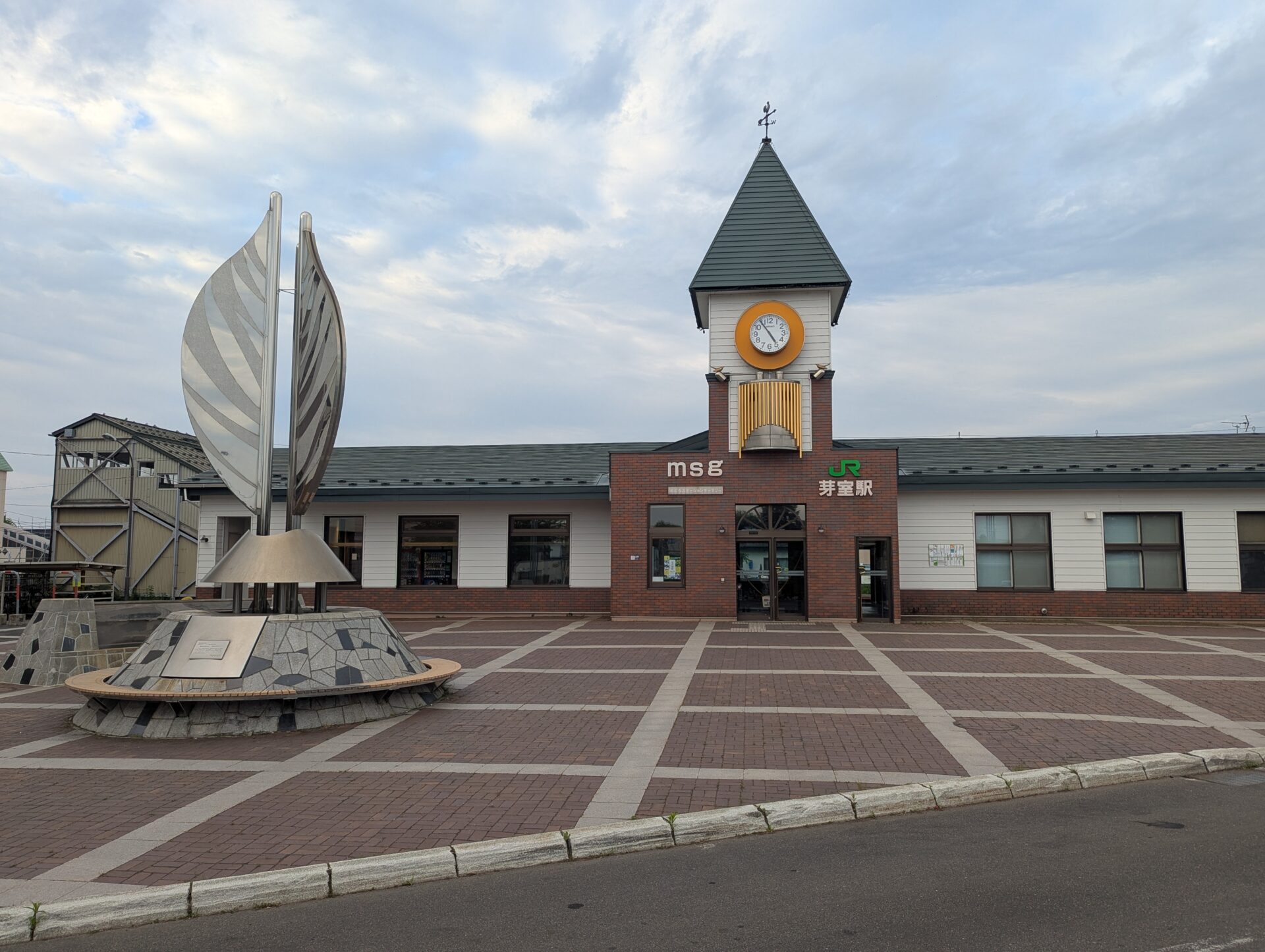 芽室駅前の広場、時計塔とモニュメントが立つレンガ敷きの駅舎前