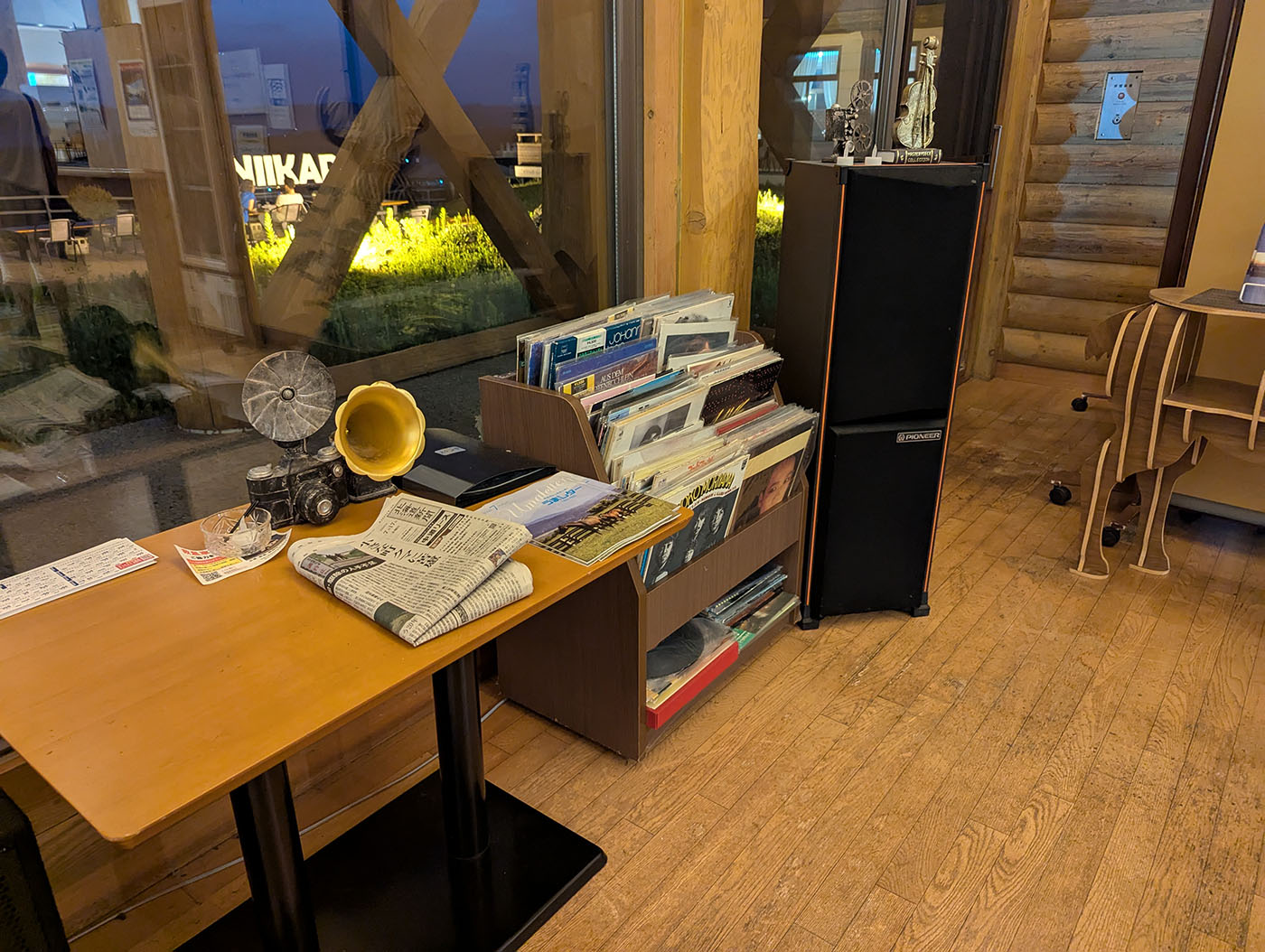 窓際に置かれたレコードラックとスピーカー。小さなアンティークのオブジェも並ぶ