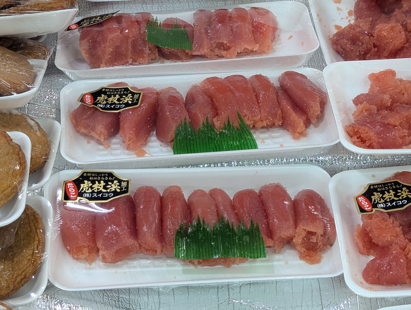 スイコウ製造の虎杖浜のたらこがずらりと並ぶ生鮮市場の店頭。鮮やかな紅色と粒感が食欲をそそる。