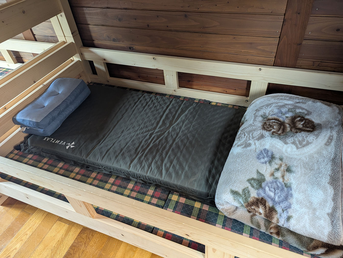 ロッジの二段ベッドに敷かれたエアマット、まくら、毛布の寝床セット