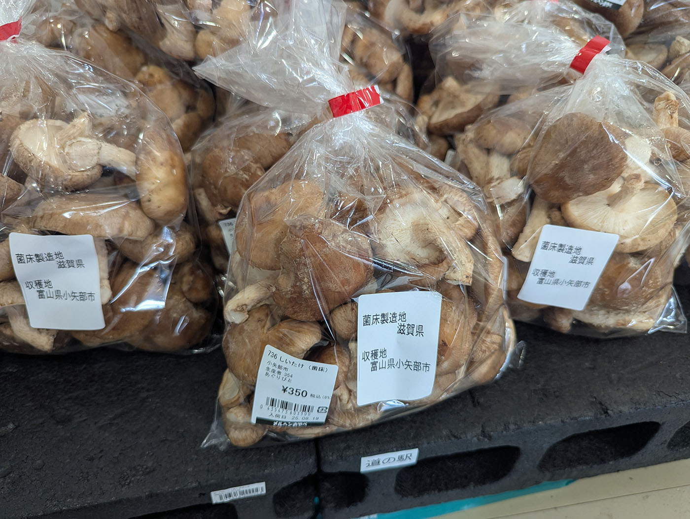 道の駅メルヘンおやべの直売所に並ぶ袋詰めの生しいたけ。富山県小矢部市産の原木しいたけが透明な袋に詰められ、350円の価格表示がついている。